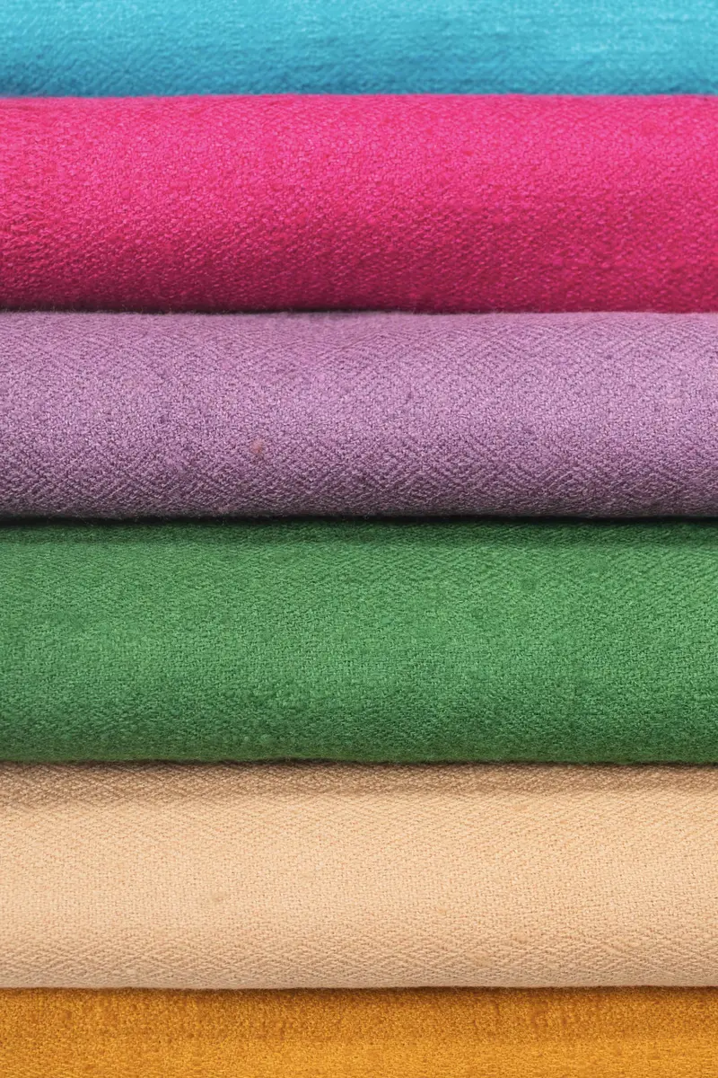 Basoli shawls stacked in turquoise, pink, lilac, green, peach and ochre