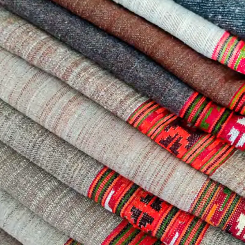 Stacked Himalayan wool throws with woven borders